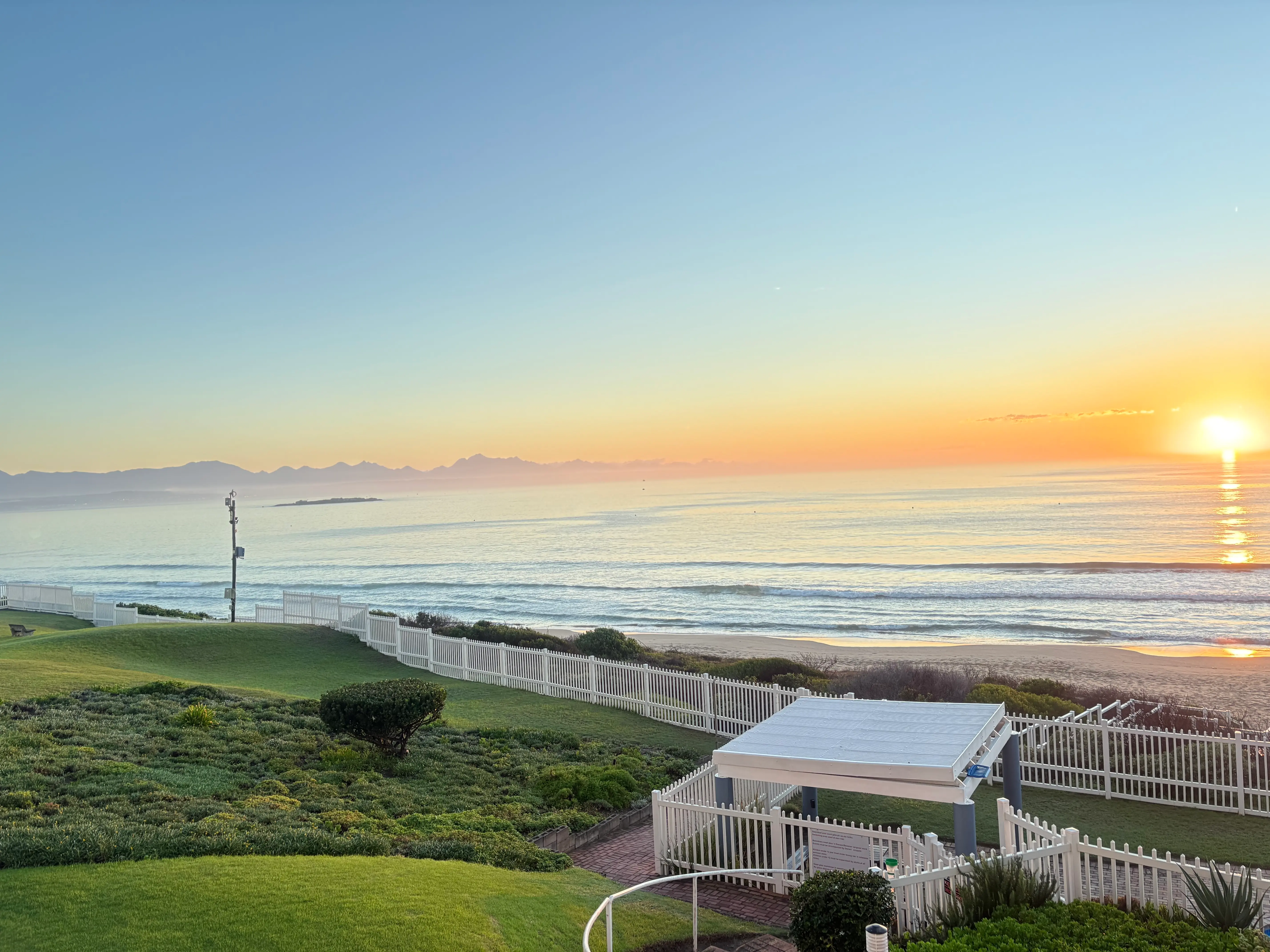Balcony view with grass and ocean